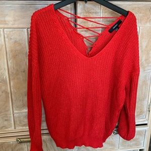 Red knitted top with criss cross open v neck on back. Smoke & pet free home.